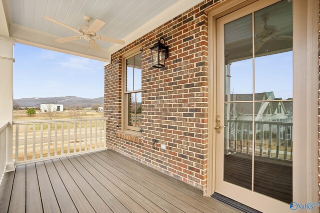 deck featuring ceiling fan and a mountain view