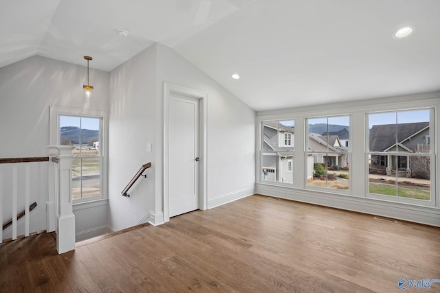 bonus room featuring wood-type flooring and vaulted ceiling