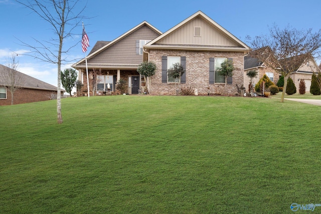 craftsman house featuring brick siding and a front lawn