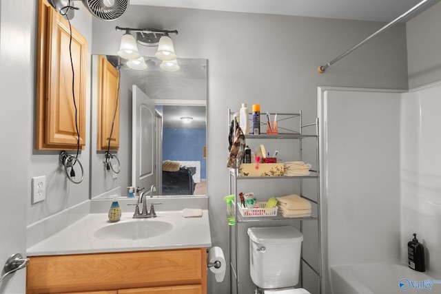 bathroom with toilet,  shower combination, and vanity