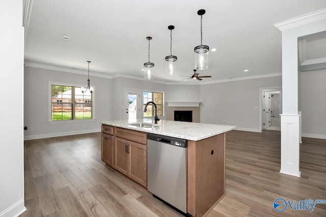 kitchen with pendant lighting, sink, stainless steel dishwasher, ceiling fan, and a center island with sink