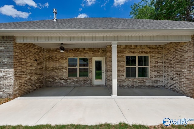 view of exterior entry featuring a patio area and ceiling fan