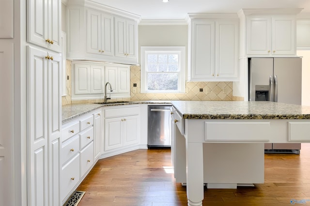 kitchen with dishwasher, light stone counters, a kitchen island, and white cabinets