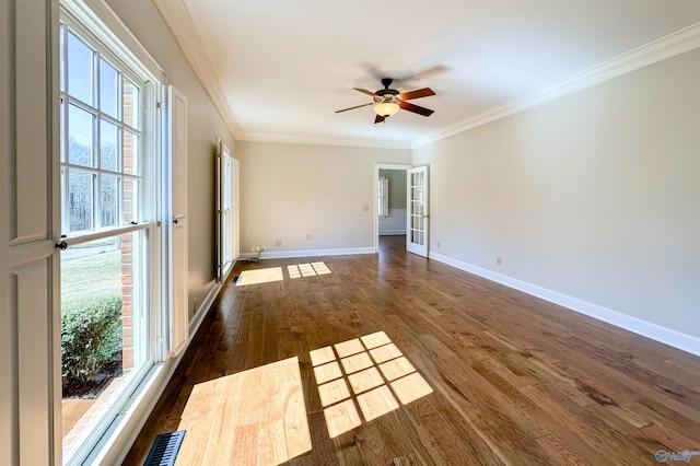 unfurnished room featuring ceiling fan, baseboards, french doors, dark wood-style floors, and crown molding