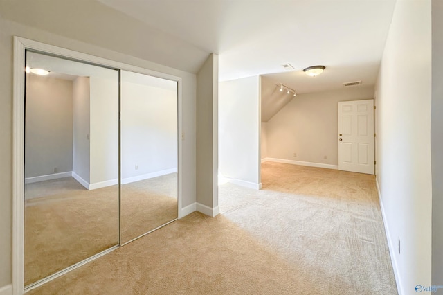 bonus room featuring light carpet, baseboards, visible vents, and vaulted ceiling