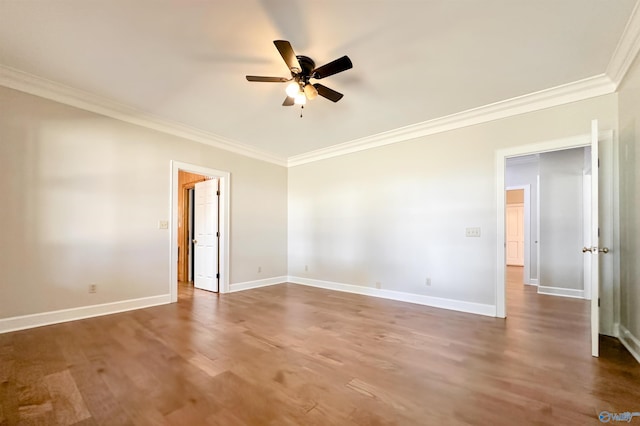 unfurnished room with ceiling fan, ornamental molding, dark wood finished floors, and baseboards