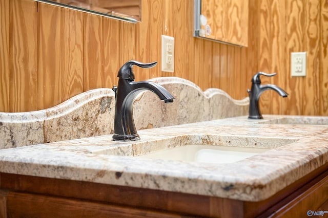 interior details featuring wooden walls and vanity