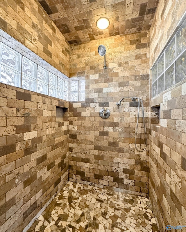 bathroom with tiled shower