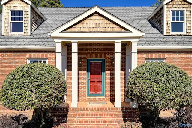 doorway to property featuring brick siding