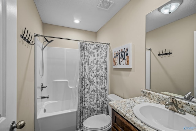 bathroom with visible vents, toilet, vanity, and shower / tub combo with curtain
