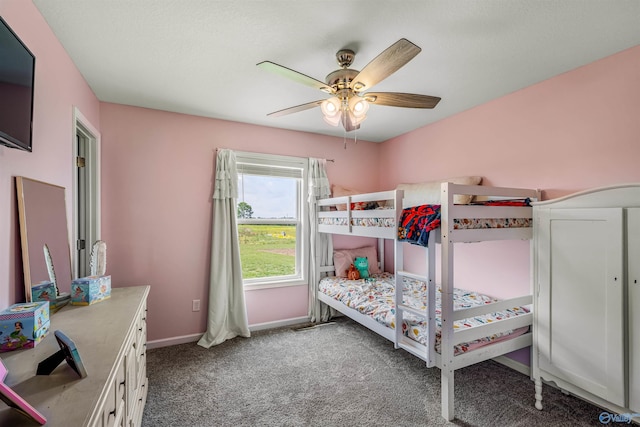 bedroom with baseboards, a ceiling fan, and carpet