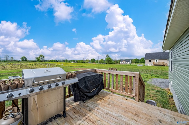 deck featuring a lawn and a rural view