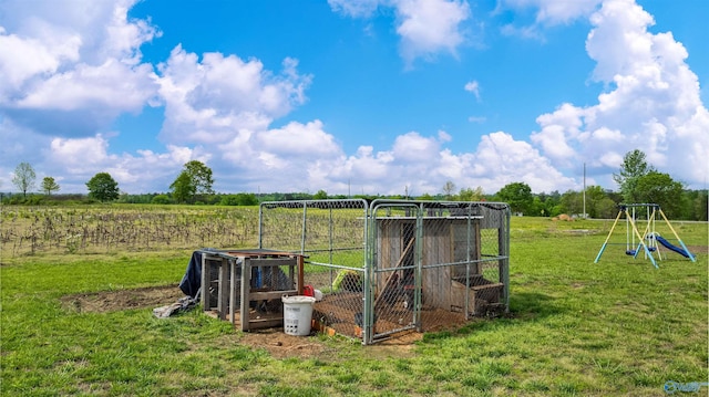 view of yard with a rural view, exterior structure, and an outbuilding