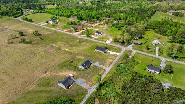 birds eye view of property with a forest view