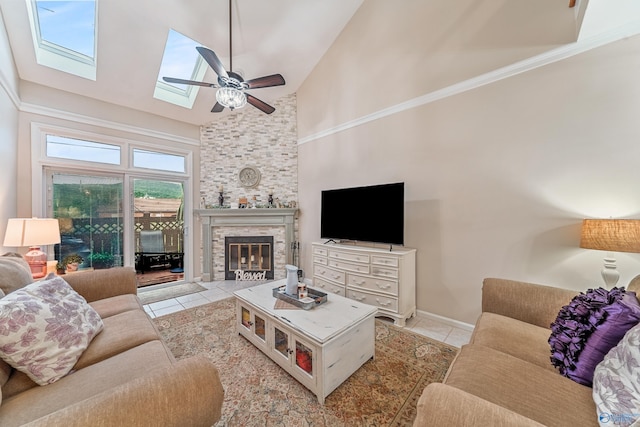 living area featuring ceiling fan, tile patterned floors, a fireplace, and high vaulted ceiling