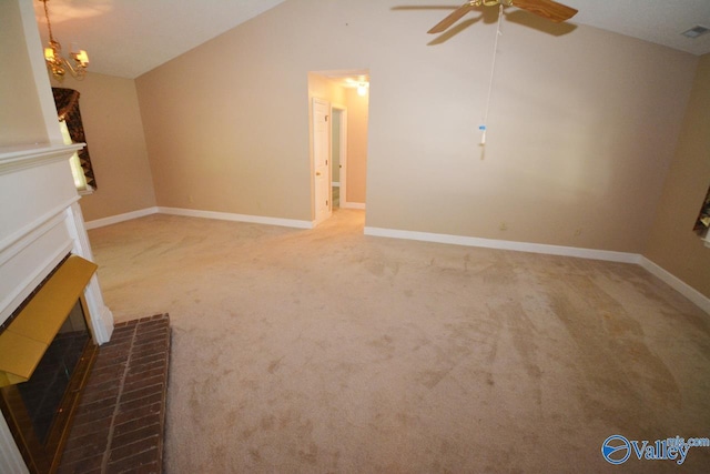 unfurnished living room with lofted ceiling, carpet floors, ceiling fan, and a brick fireplace