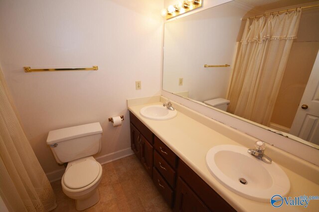 bathroom with toilet, tile patterned floors, and double vanity