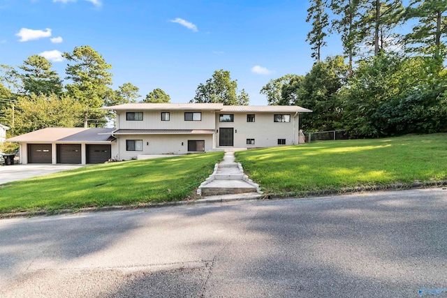 split foyer home featuring a front lawn and a garage