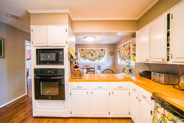 kitchen featuring hardwood / wood-style flooring, black appliances, and white cabinetry