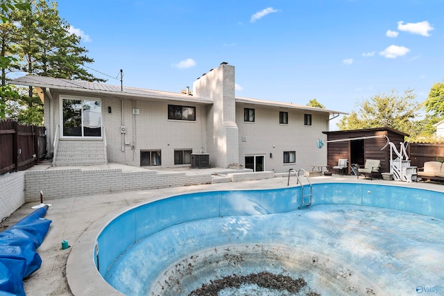 view of swimming pool featuring central air condition unit