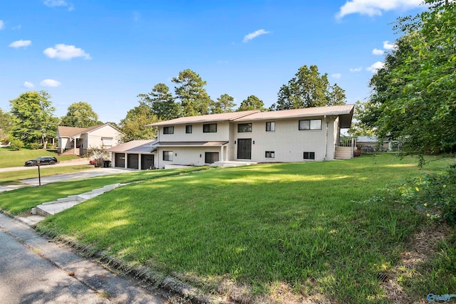 view of front of home with a garage and a front yard