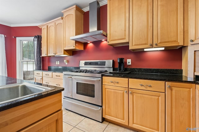 kitchen with range with two ovens, light brown cabinetry, light tile patterned floors, crown molding, and wall chimney range hood