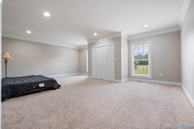 unfurnished bedroom featuring a closet, crown molding, and light colored carpet