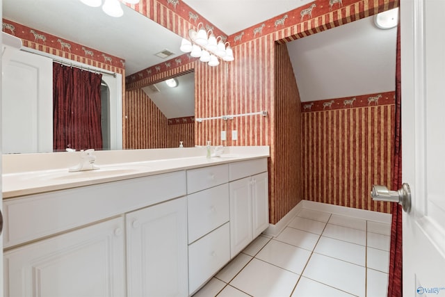 bathroom featuring tile patterned floors and dual bowl vanity