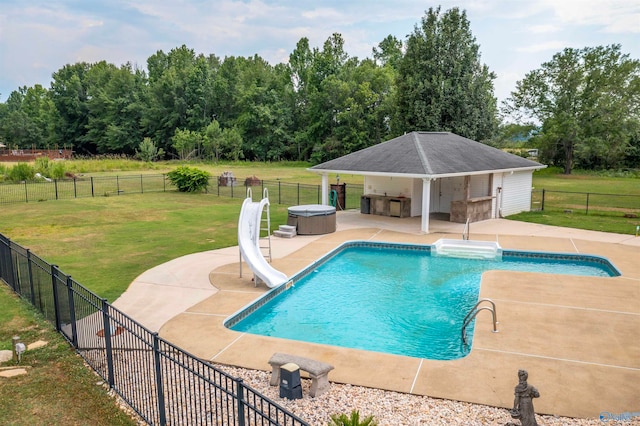 view of swimming pool featuring a patio, a yard, and a water slide