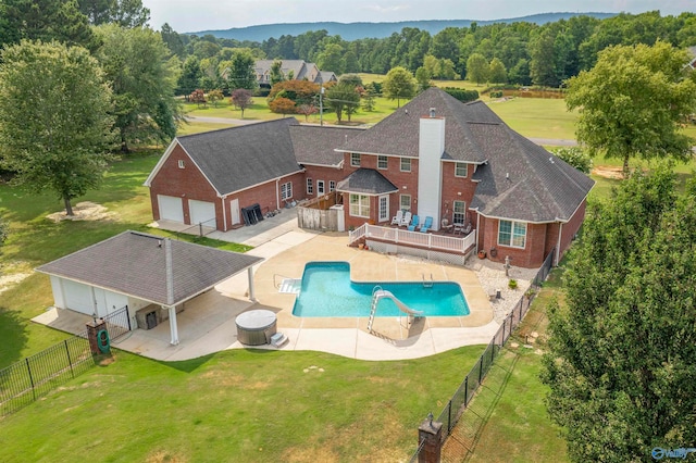 view of swimming pool featuring a lawn, a patio area, and a deck