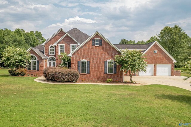 view of front of house featuring a garage and a front lawn