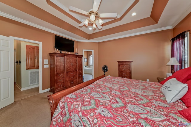 carpeted bedroom with ornamental molding, connected bathroom, ceiling fan, and a raised ceiling