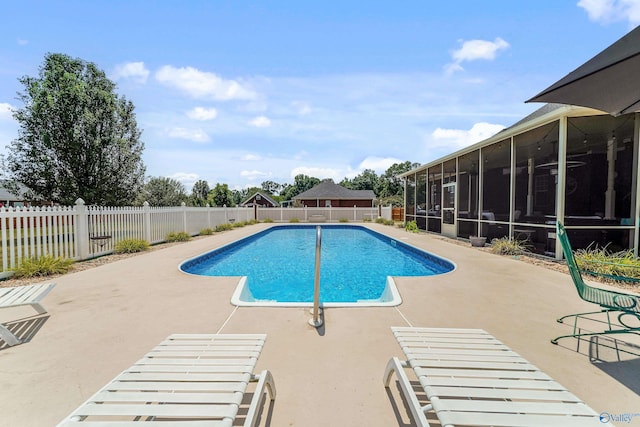 view of swimming pool featuring a sunroom and a patio