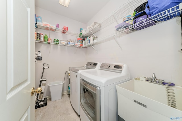 laundry area with washer and clothes dryer and sink