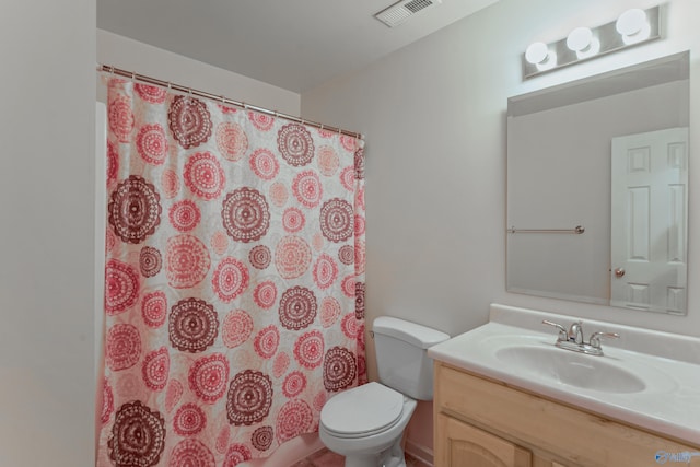 bathroom featuring vanity, toilet, and curtained shower