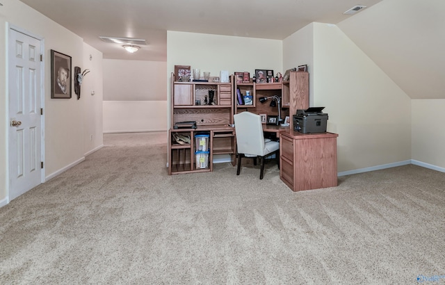 carpeted home office featuring vaulted ceiling