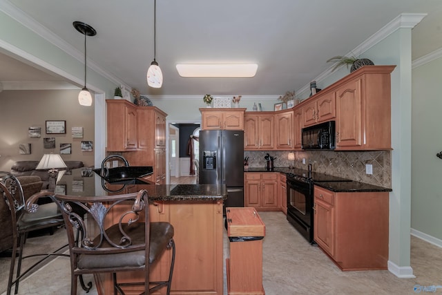 kitchen featuring pendant lighting, sink, kitchen peninsula, black appliances, and crown molding