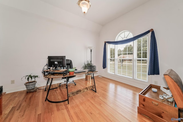 office with lofted ceiling and hardwood / wood-style floors