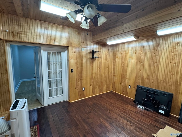 unfurnished room featuring ceiling fan, wooden walls, dark hardwood / wood-style flooring, and wooden ceiling