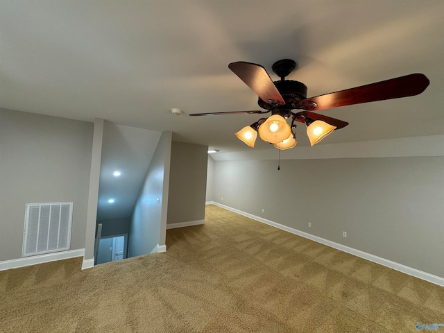 unfurnished room featuring ceiling fan, vaulted ceiling, and carpet