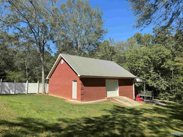 view of outbuilding with a yard