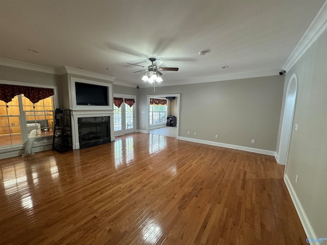 unfurnished living room featuring ceiling fan, crown molding, and hardwood / wood-style floors