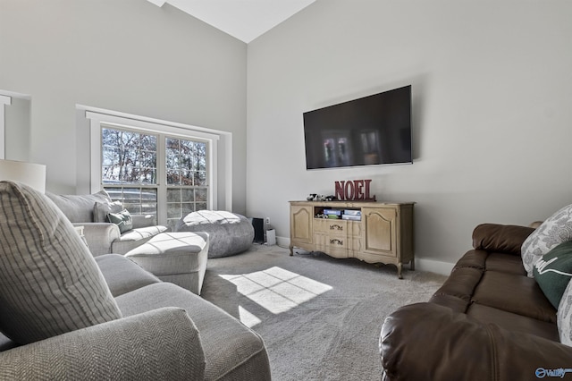 carpeted living room featuring high vaulted ceiling