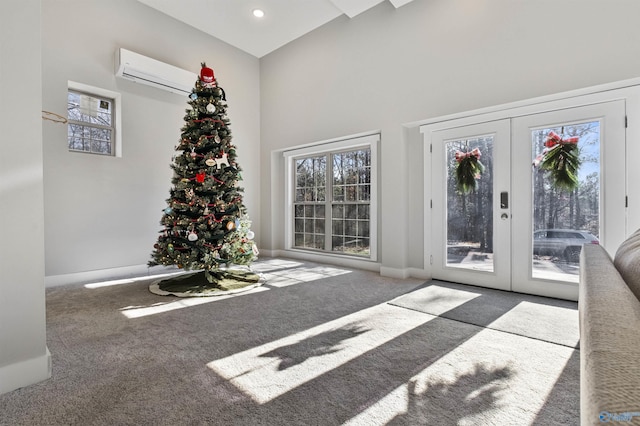 interior space with dark carpet, french doors, a wall unit AC, and a high ceiling