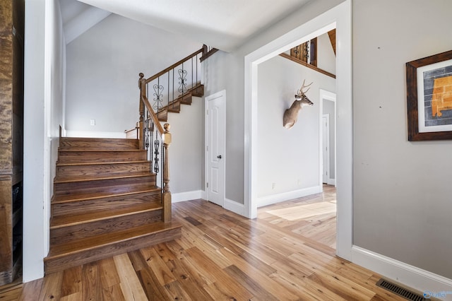 staircase with wood-type flooring