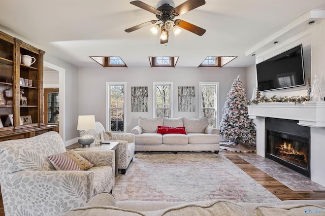 living room featuring wood-type flooring and ceiling fan