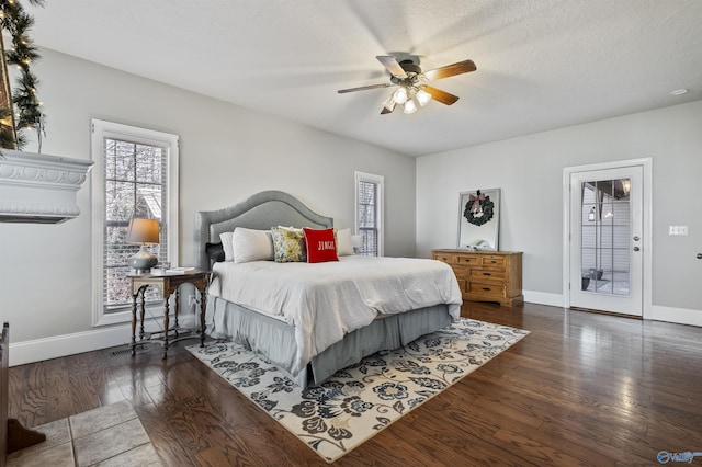 bedroom with access to outside, ceiling fan, a textured ceiling, and dark hardwood / wood-style floors