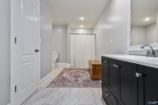 bathroom featuring vanity, toilet, and walk in shower