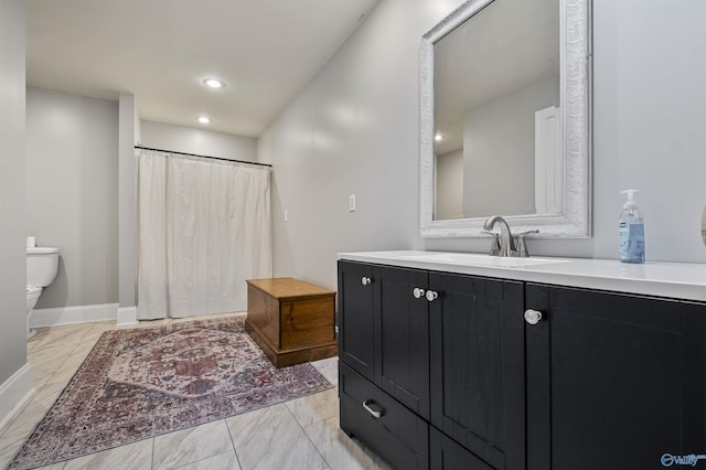 bathroom featuring vanity and toilet