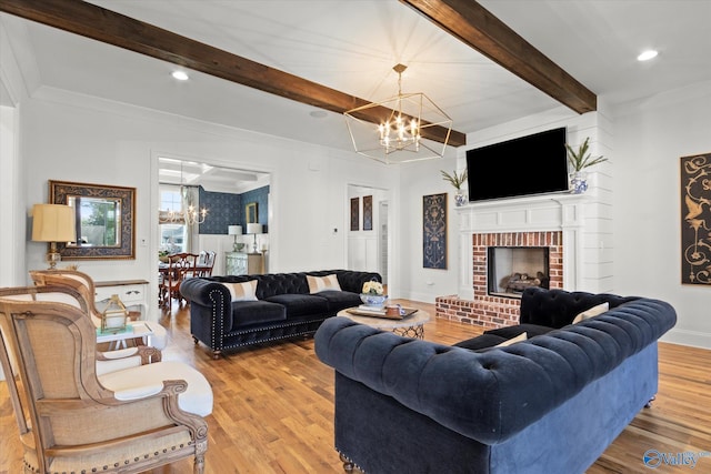 22424 Cantera Dr, Athens, AL 35613 - living area featuring a chandelier, wood finished floors, beam ceiling, ornamental molding, and a fireplace